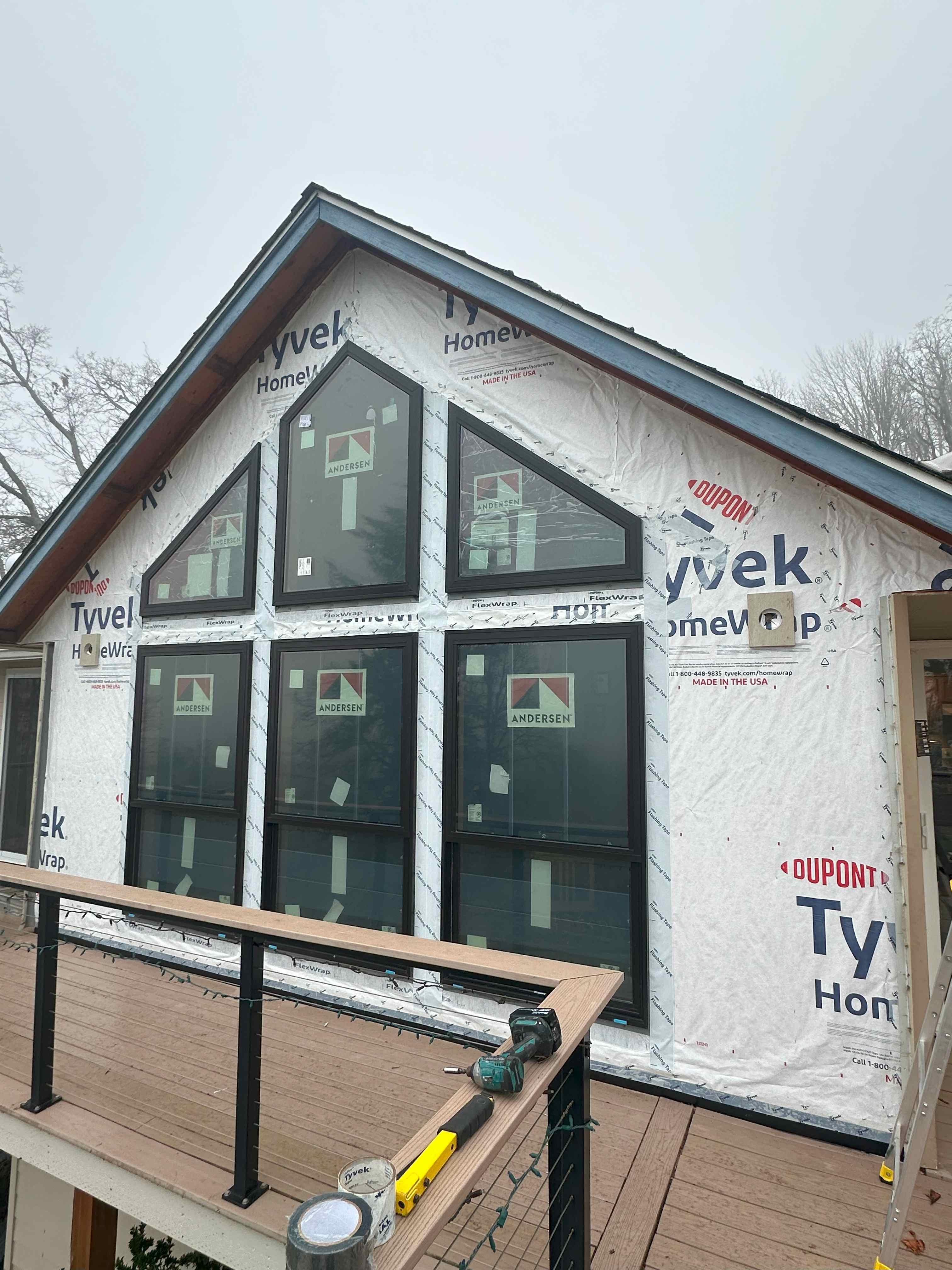 Quality Andersen windows being installed with proper weatherproofing